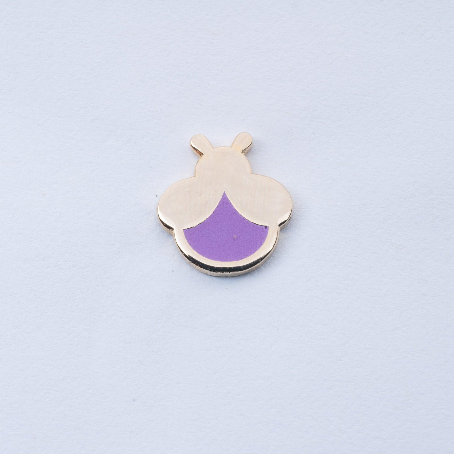 gold plated mini firefly enamel pin with lavender body that glows in the dark