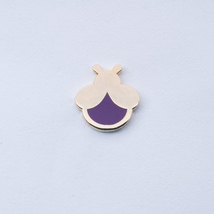gold plated mini firefly enamel pin with purplse body that glows in the dark